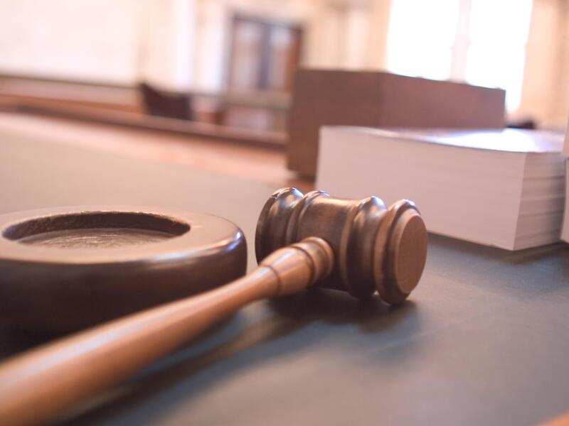Wooden gavel resting in a Singapore courtroom, symbolising contempt of court and committal proceedings