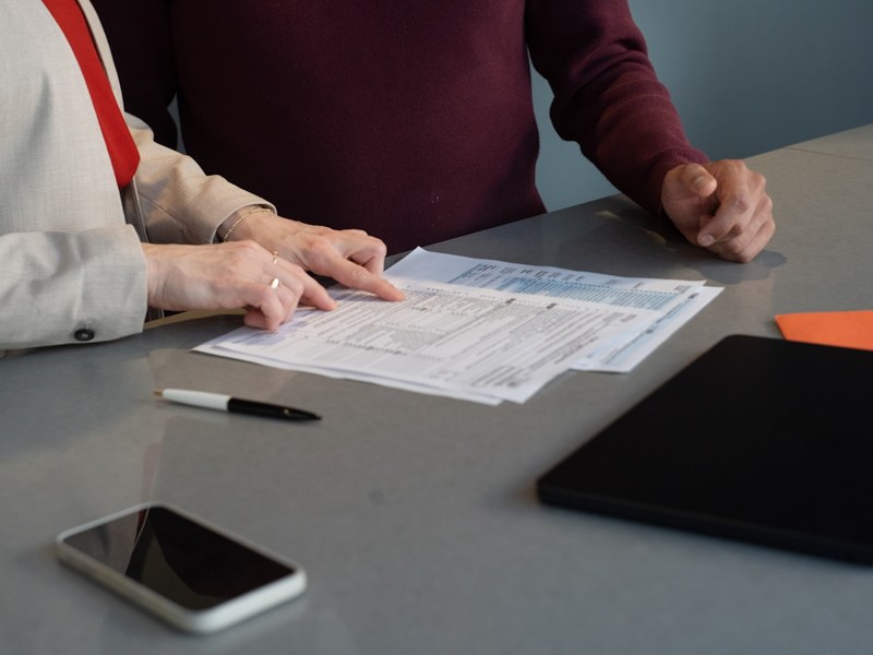 Two people reviewing documents at a table