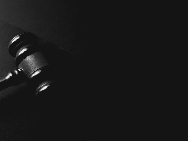 Wooden gavel on a dark surface