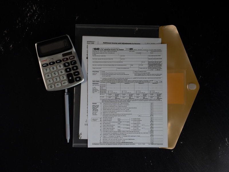 Calculator and financial papers in a folder