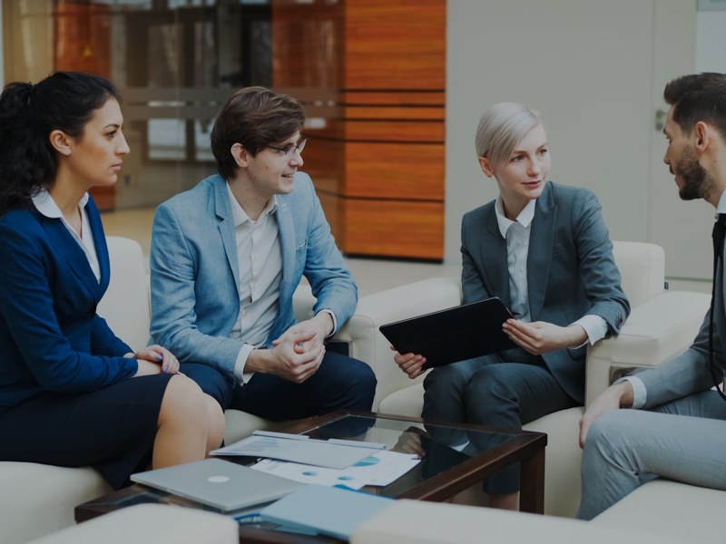 Colleagues discussing documents in a meeting