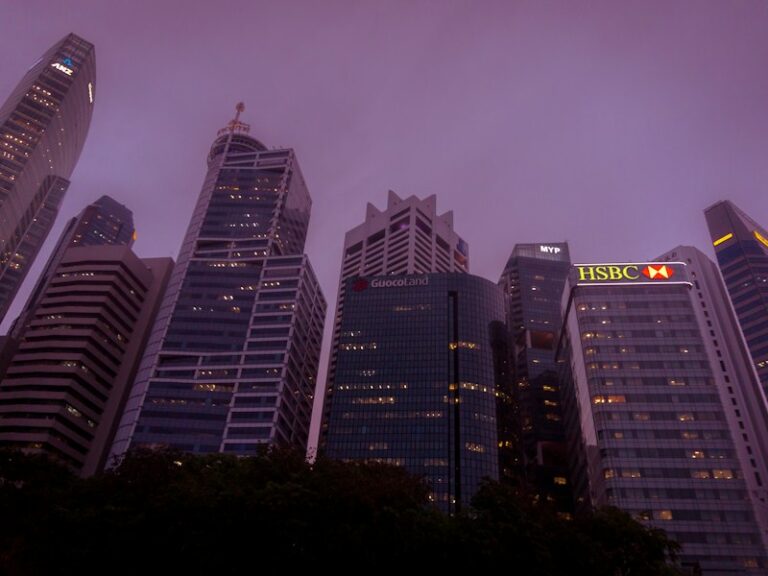 Low-angle view of office towers in Singapore's business district on a cloudy evening