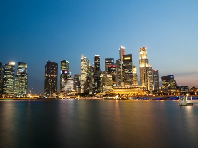 Singapore central business district skyline at dusk across Marina Bay
