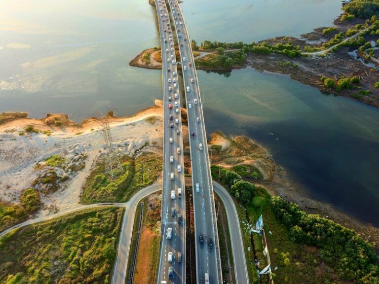 Aerial view of a dual-carriageway bridge crossing water beside mangroves near Permas Jaya, Johor