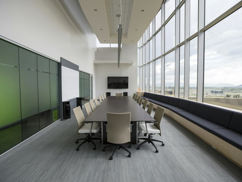 Empty boardroom with a long wooden table and chairs, the kind of room where a creditors' meeting is held