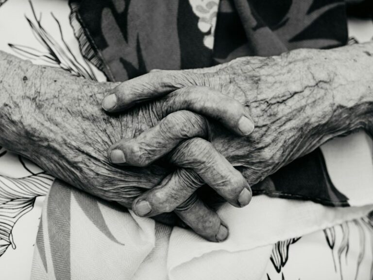 Close-up of elderly hands clasped together, illustrating a company director who has lost mental capacity