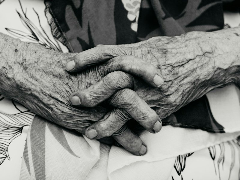 Close-up of elderly hands clasped together, illustrating a company director who has lost mental capacity