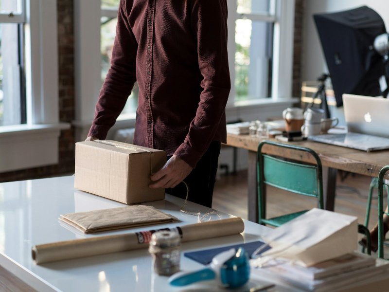 Employee holding a cardboard box after a retrenchment exercise in Singapore