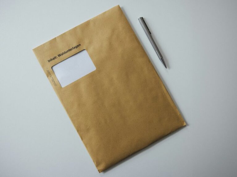 A brown envelope with a pen resting on top, representing court papers delivered to a company's registered office