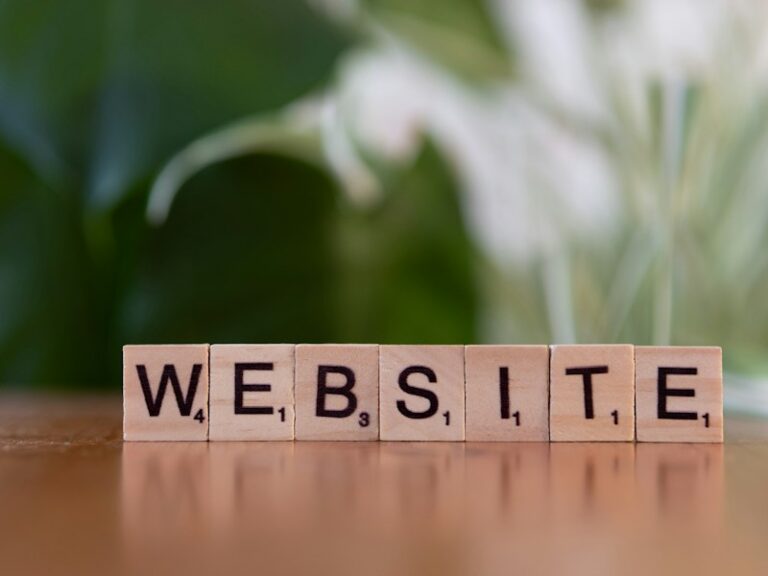 Wooden letter tiles spelling the word website on a wooden table