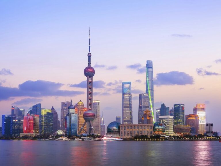 Shanghai Pudong skyline with the Oriental Pearl Tower across the Huangpu River at dusk