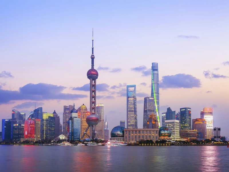 Shanghai Pudong skyline with the Oriental Pearl Tower across the Huangpu River at dusk