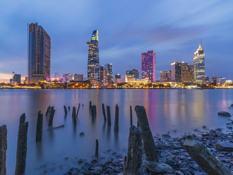 Ho Chi Minh City skyline with the Bitexco Financial Tower across the Saigon River at dusk
