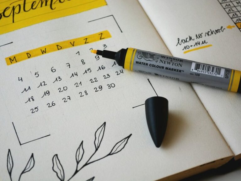 Hand-drawn monthly calendar in an open planner with a yellow marker, representing the timeline for incorporating a Singapore company