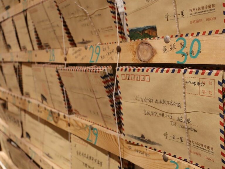 Rows of airmail envelopes pinned on wooden shelves, illustrating mail handled at a company's registered address