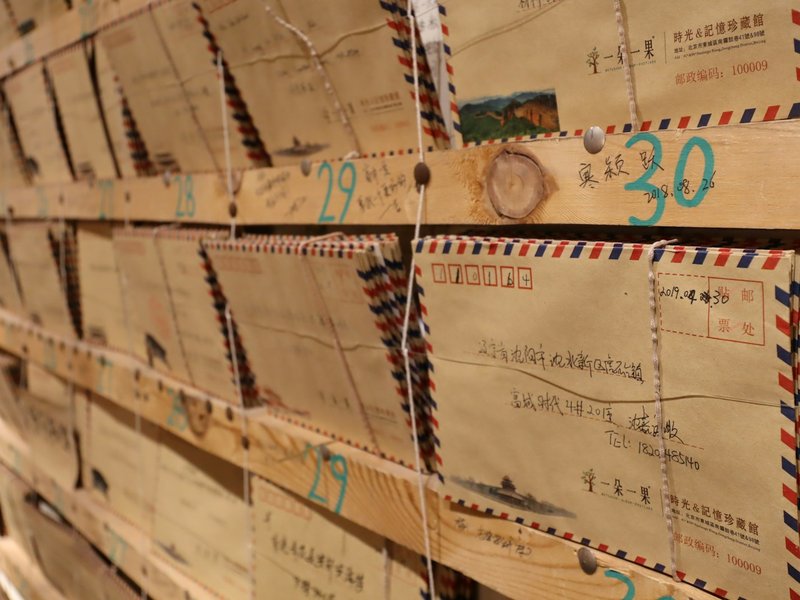 Rows of airmail envelopes pinned on wooden shelves, illustrating mail handled at a company's registered address